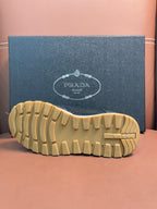 Prada unisex sneaker outsole, beige ribbed tread and raised heel section.