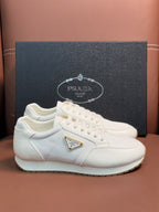 Prada unisex sneakers, white lace-up with triangular logo badge and chunky sole
