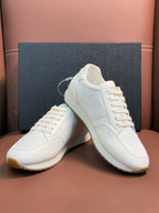 Prada unisex sneakers, white lace-up shoes with chunky sole and gold emblem detail