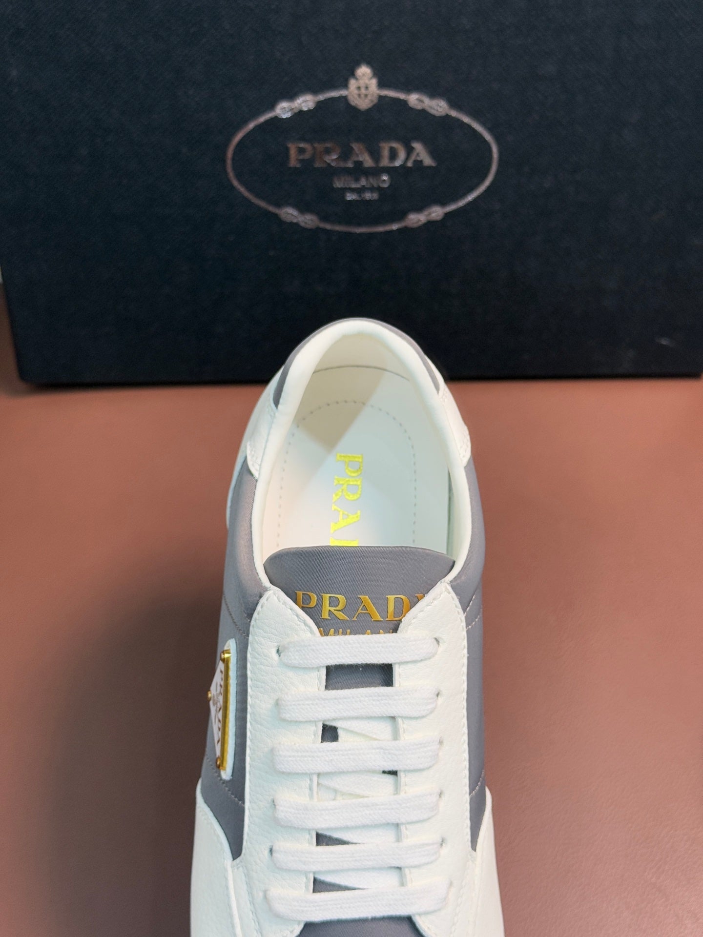 Prada unisex sneakers, front close-up with white laces and gray side panel