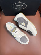 Prada unisex leather sneakers, white upper with gray side panel and triangle logo