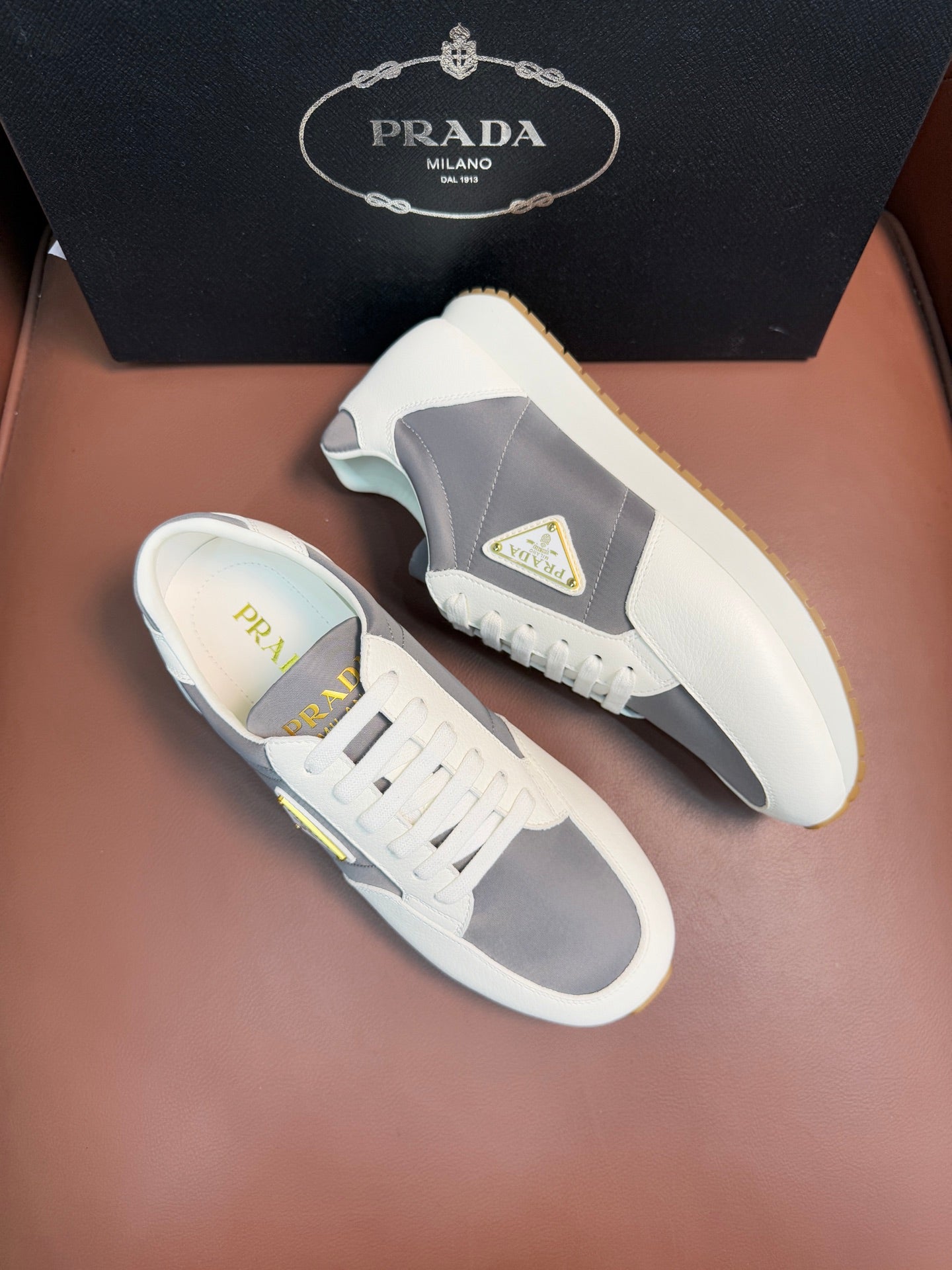 Prada unisex leather sneakers, white upper with gray side panel and triangle logo