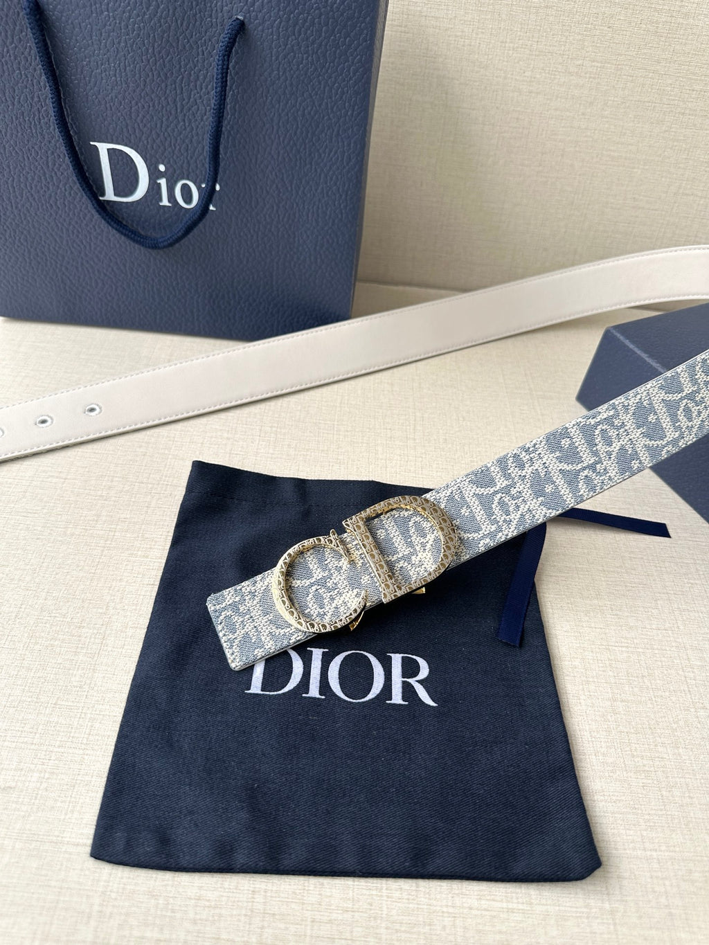 Dior logo belt with blue patterned strap and oval gold-tone buckle