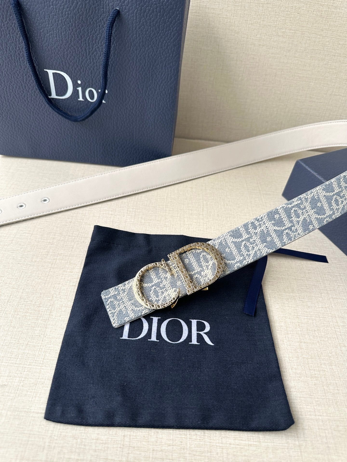 Dior logo belt with blue patterned strap and oval gold-tone buckle
