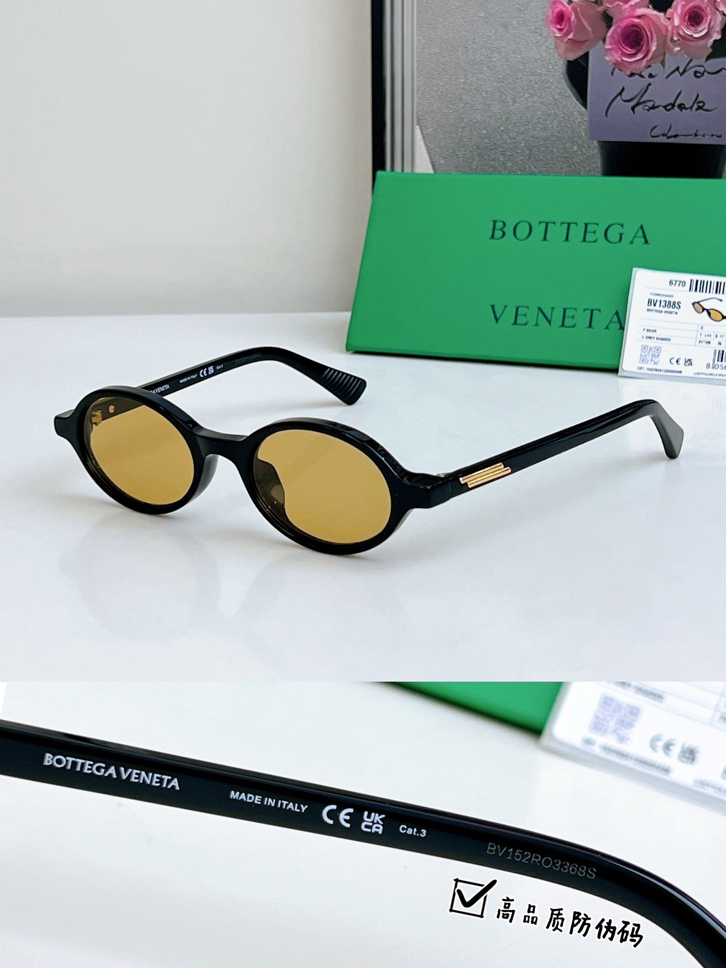 Bottega Veneta oval sunglasses with black frames and yellow tinted lenses, gold temple detail.