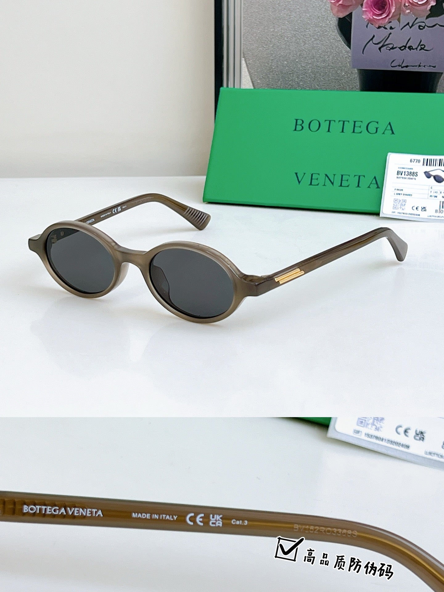 Bottega Veneta oval sunglasses with brown frames and dark lenses, gold temple detail.