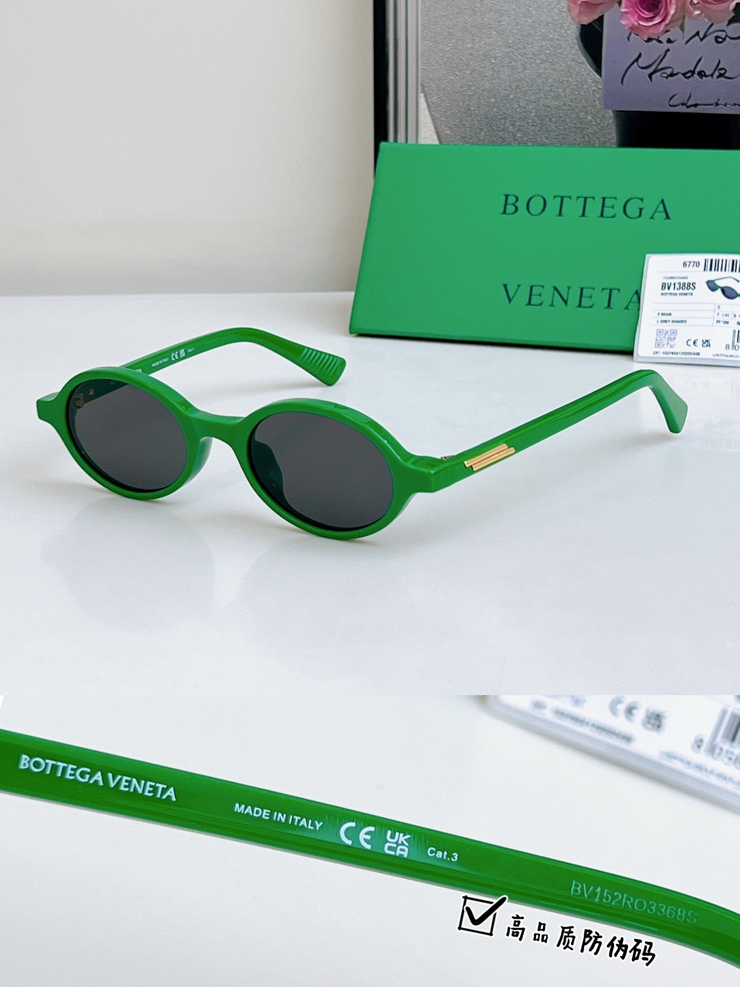 Bottega Veneta oval sunglasses with green frames and dark lenses, gold temple detail.