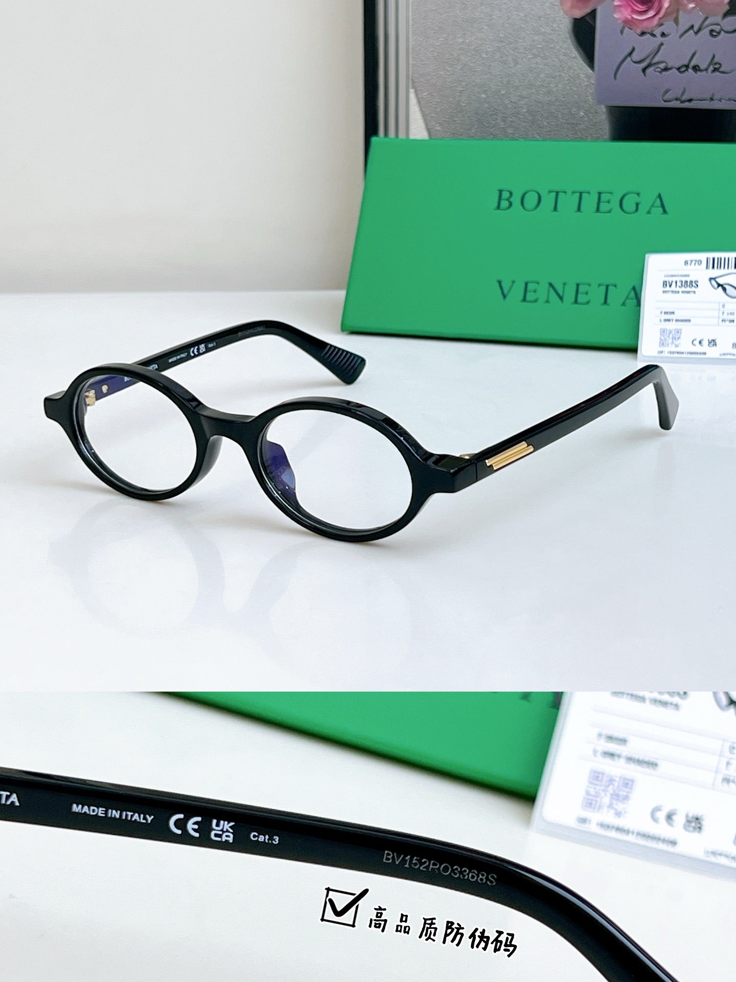 Bottega Veneta oval sunglasses with dark frames and blue-tinted lenses, gold temple accent.
