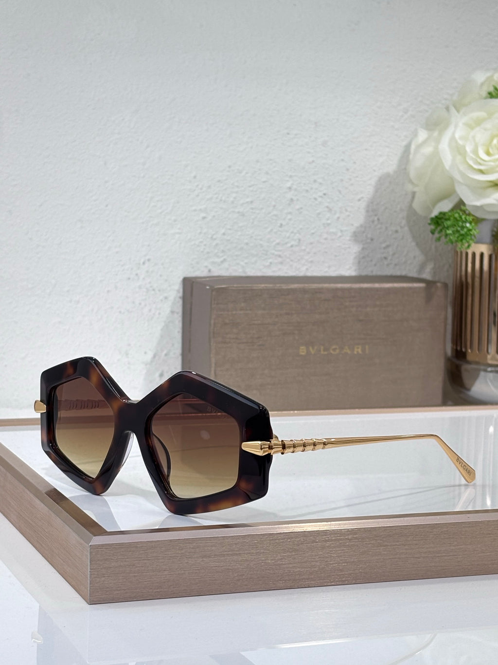 Sunglasses, dark oversized square frames with brown tinted lenses and gold temples