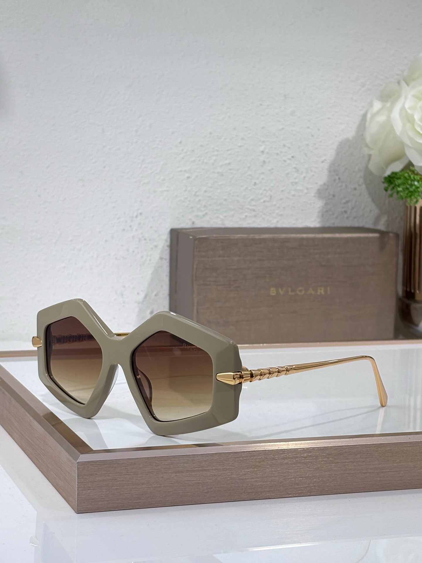 Sunglasses, light gray oversized square frames with brown tinted lenses and gold temples