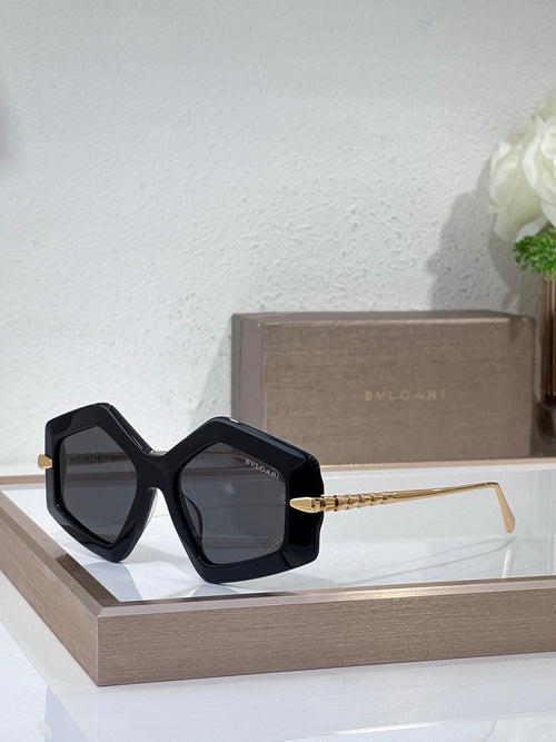 Sunglasses, black oversized square frames with dark tinted lenses and gold temples