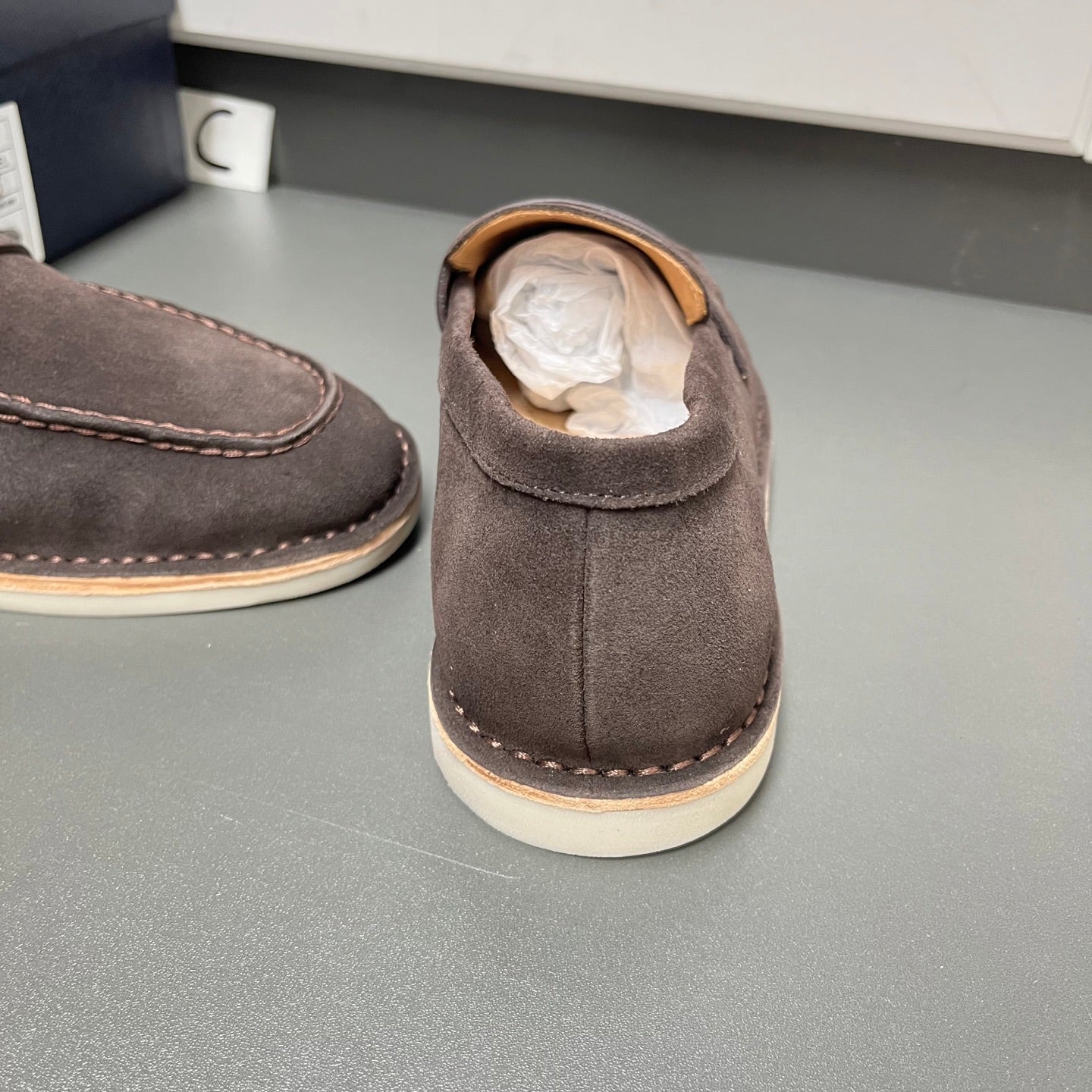 Prada unisex suede loafer heel, showing collar opening and paper lining inside