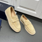 Beige Prada unisex loafers, angled view with top strap and moc toe