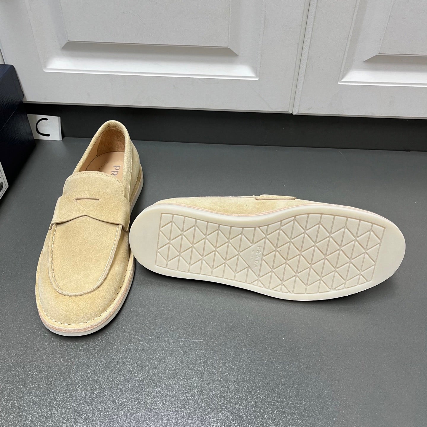 Beige Prada unisex loafers, outsole view with textured tread