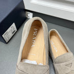 Prada unisex suede loafer with light gray upper, strap closure and visible lining