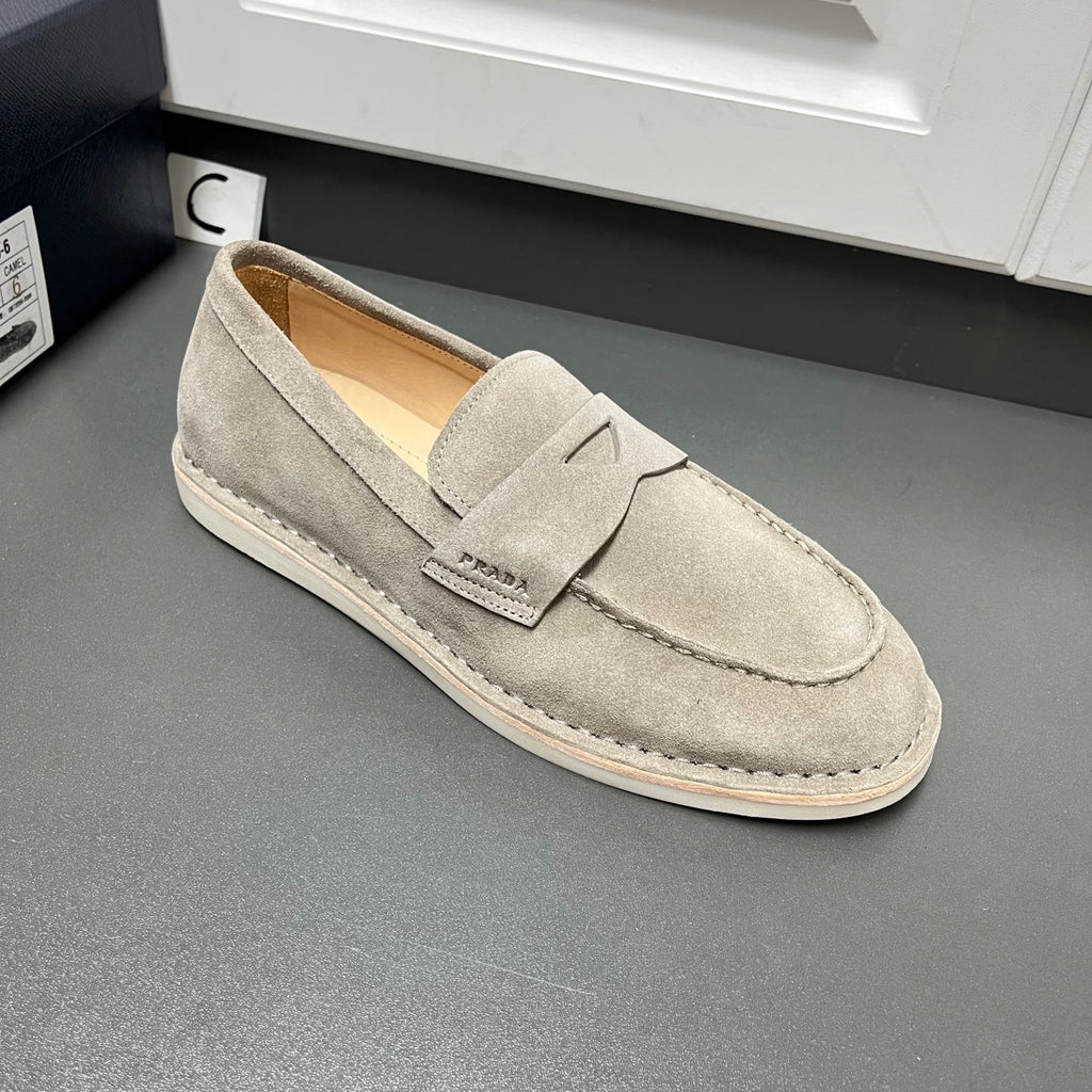 Prada unisex suede loafer in light gray, slip-on design with strap detail and seams