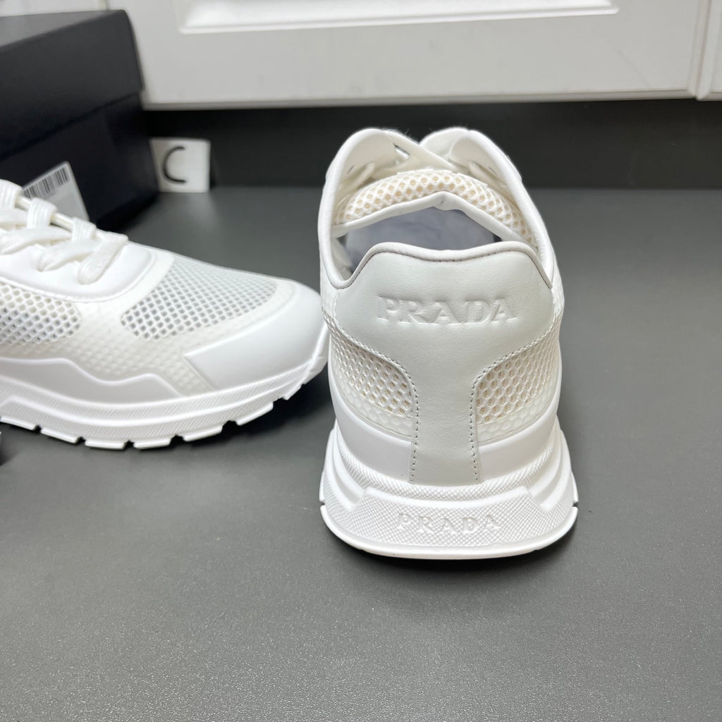 White Prada sneakers heel view with cushioned back and mesh side panels