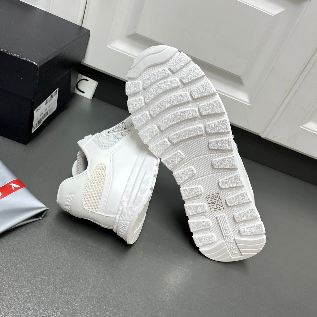 White Prada sneakers outsole view with thick rubber tread and sidewall logo