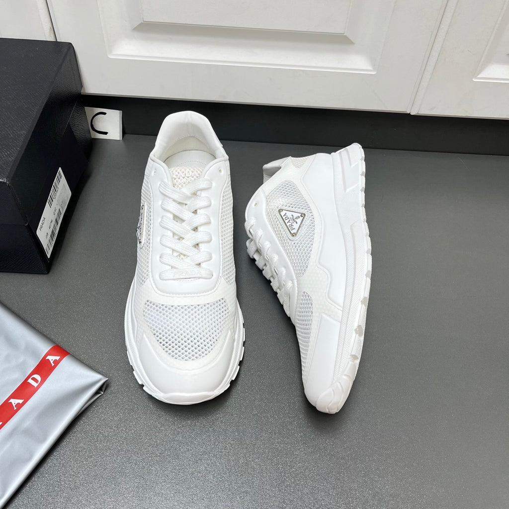 White Prada unisex sneakers with mesh uppers and chunky rubber tread sole