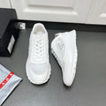 White Prada unisex sneakers with mesh uppers and chunky rubber tread sole