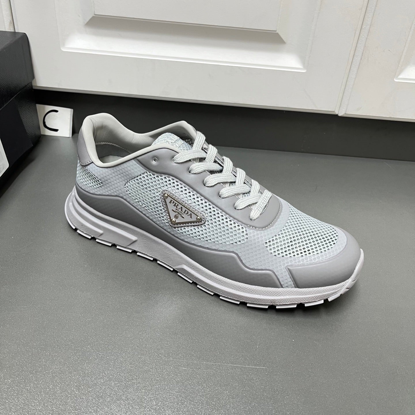 Prada unisex sneakers, light gray lace-up with textured panel and chunky white sole