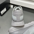 Prada unisex sneakers back view, light gray with PRADA on heel and molded sole