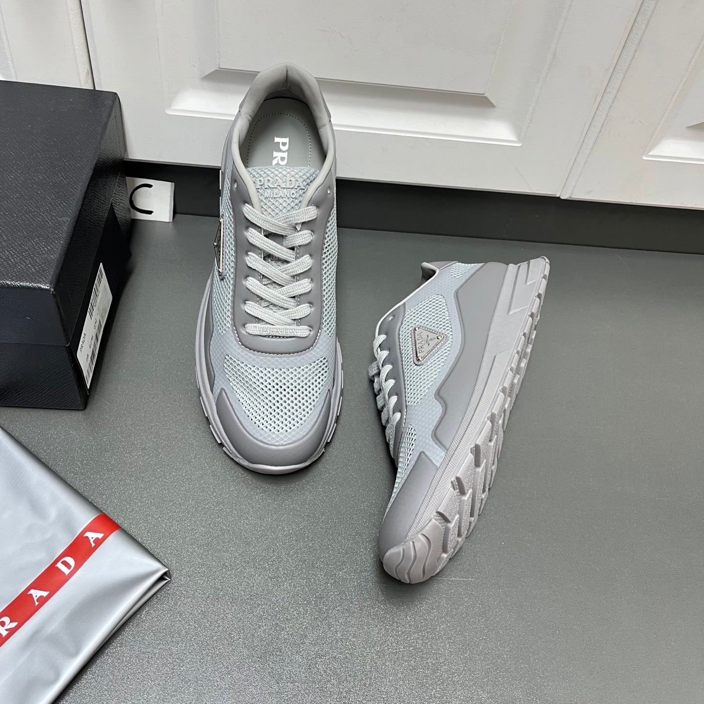 Prada unisex sneakers in light gray with mesh upper and white laces