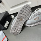 Prada unisex sneakers with outsole view, light gray tread and sidewall details