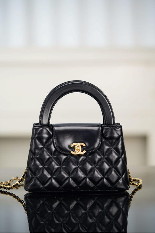 Black Chanel quilted mini handbag with top handle, chain shoulder strap