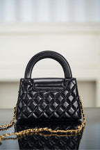 Black Chanel quilted mini handbag with front flap and chain shoulder strap