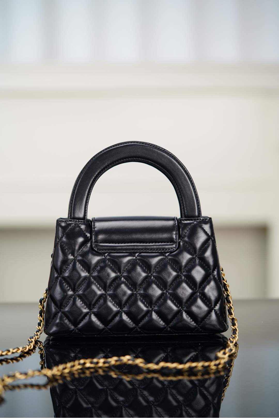 Black Chanel quilted mini handbag with front flap and chain shoulder strap