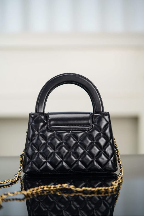 Black Chanel quilted mini handbag with front flap and chain shoulder strap