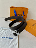 Louis Vuitton belt with black textured strap and LV buckle, stacked view.