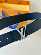 Louis Vuitton belt close-up with textured navy strap and LV metal buckle