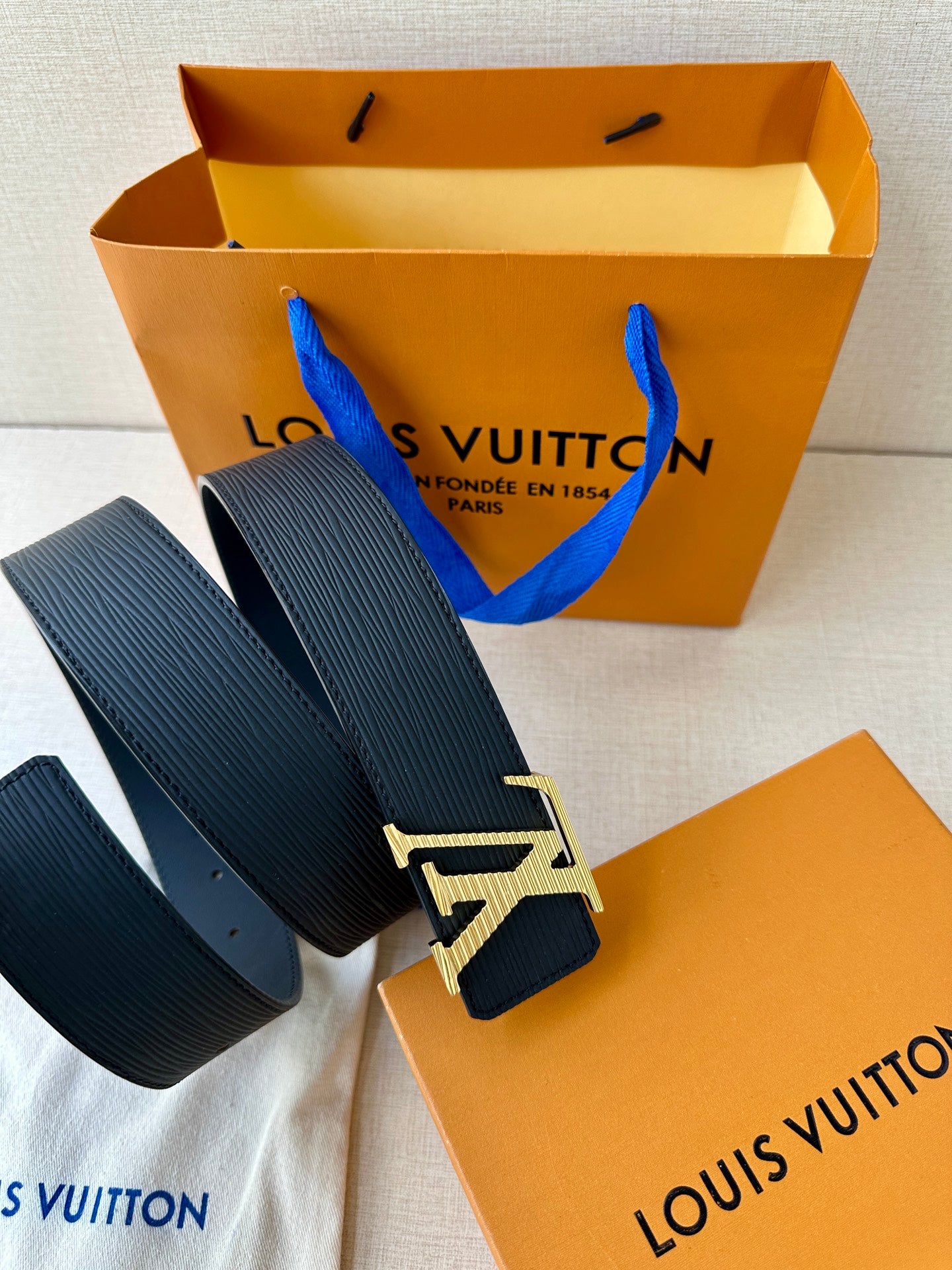 Louis Vuitton belt coiled with gold-tone LV buckle on navy strap