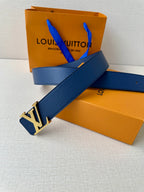 Blue leather Louis Vuitton belt with gold-tone LV buckle laid across a surface