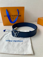 Blue leather belt with gold-tone LV buckle, resting on a fabric pouch