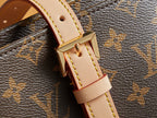 Louis Vuitton monogram strap with gold hardware and beige leather trim.