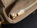 Louis Vuitton beige bag with gold zipper pull and LV monogram emblem on lining