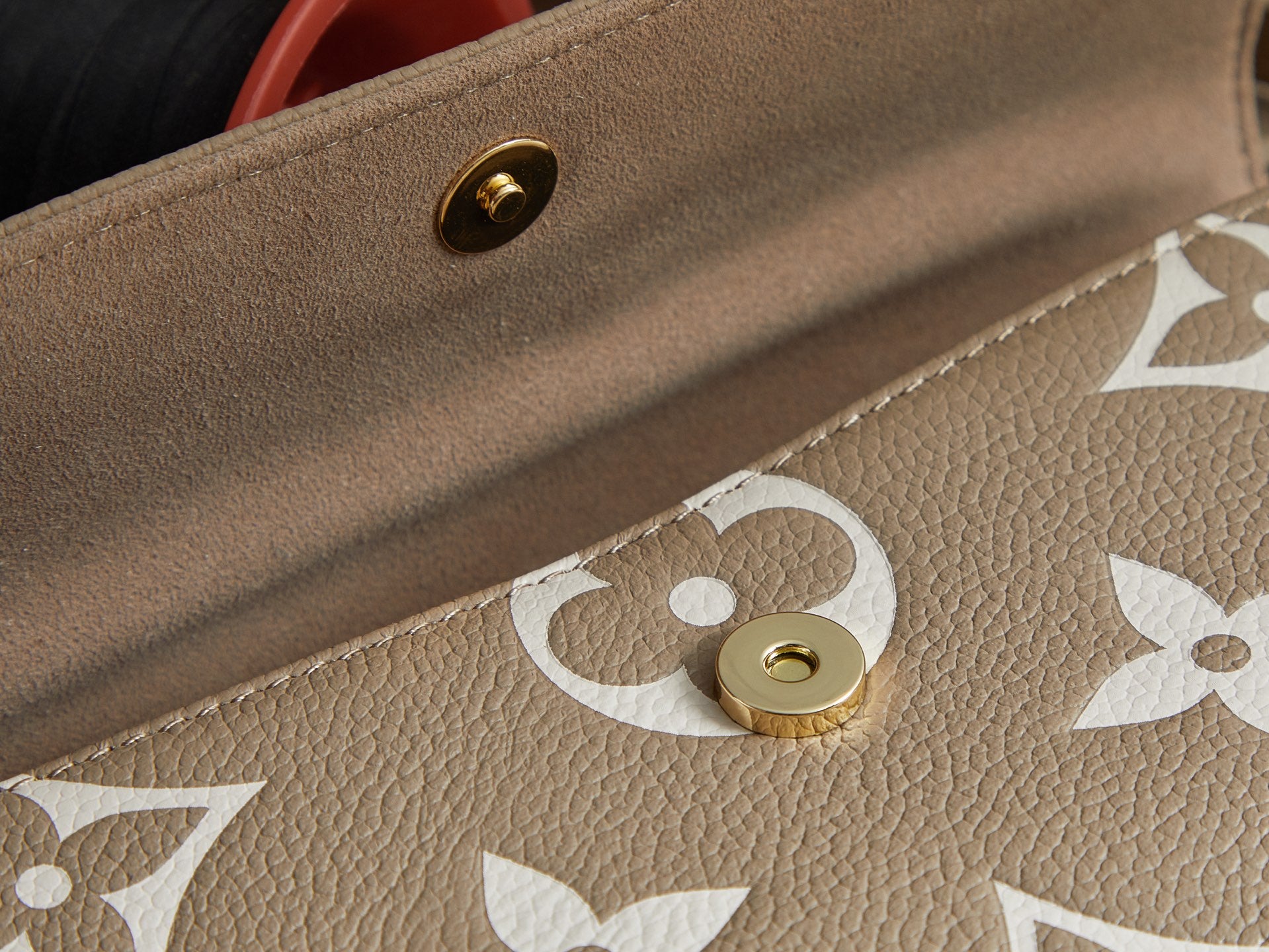 Louis Vuitton beige monogram bag corner with gold snap button and embossed pattern
