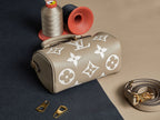 Louis Vuitton monogram handbag in beige with short handle, shoulder strap, and gold accents