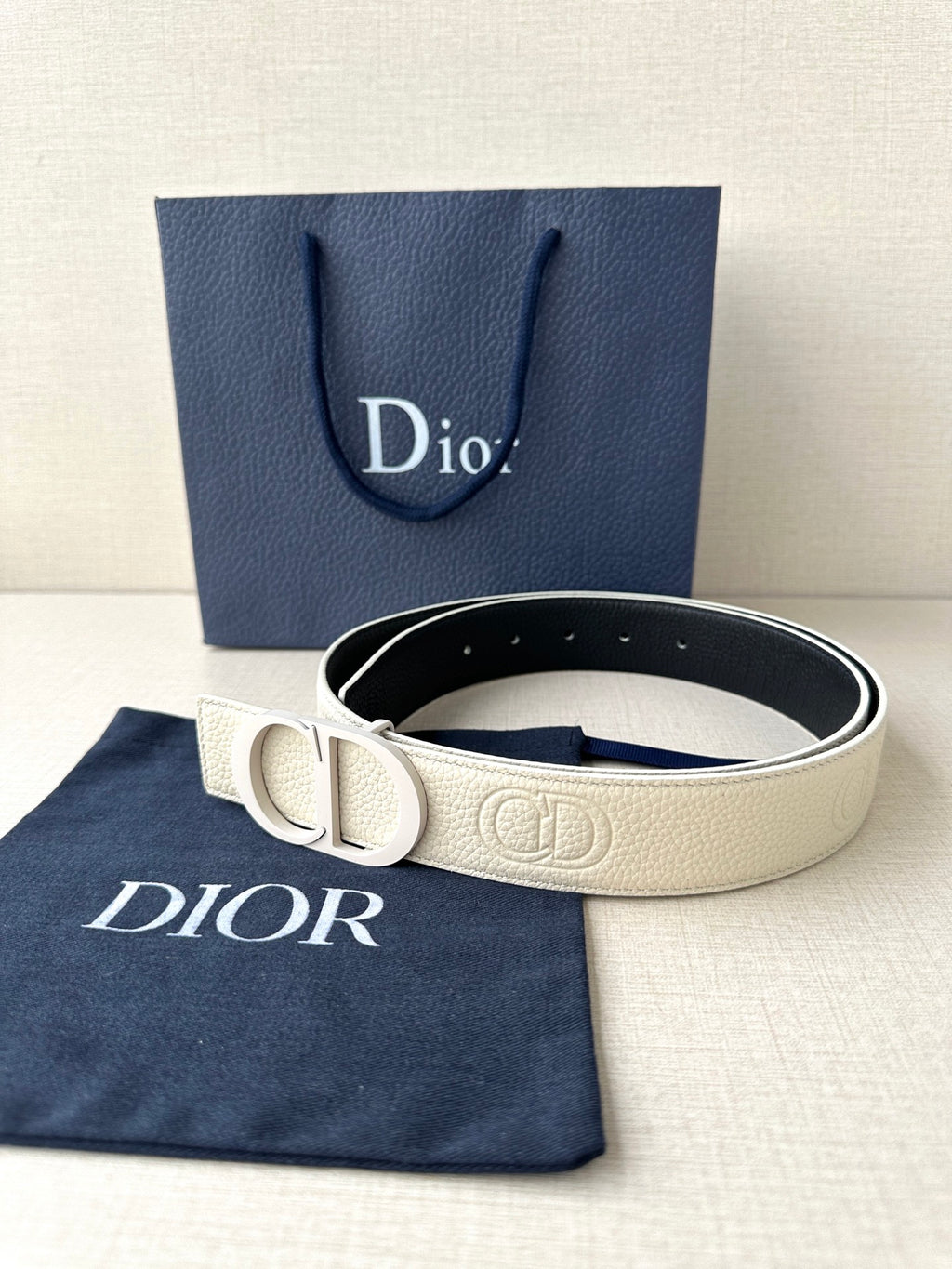 Dior belt with cream leather strap and logo buckle, dark underside visible
