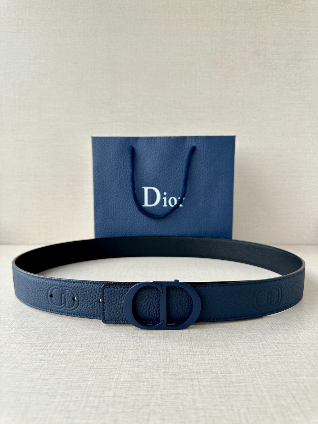 Blue leather Dior belt with embossed logo pattern and round CD buckle