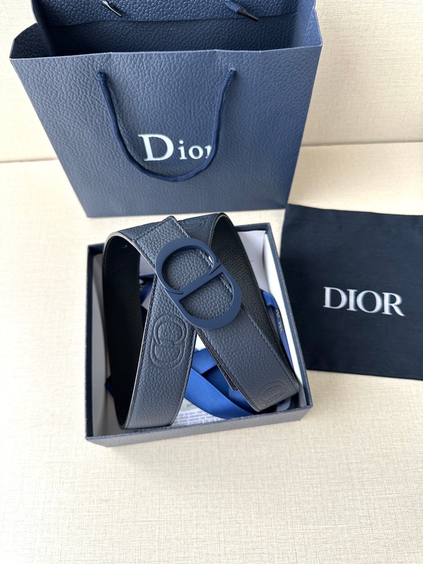 Blue leather Dior belt with CD buckle, shown in open gift box