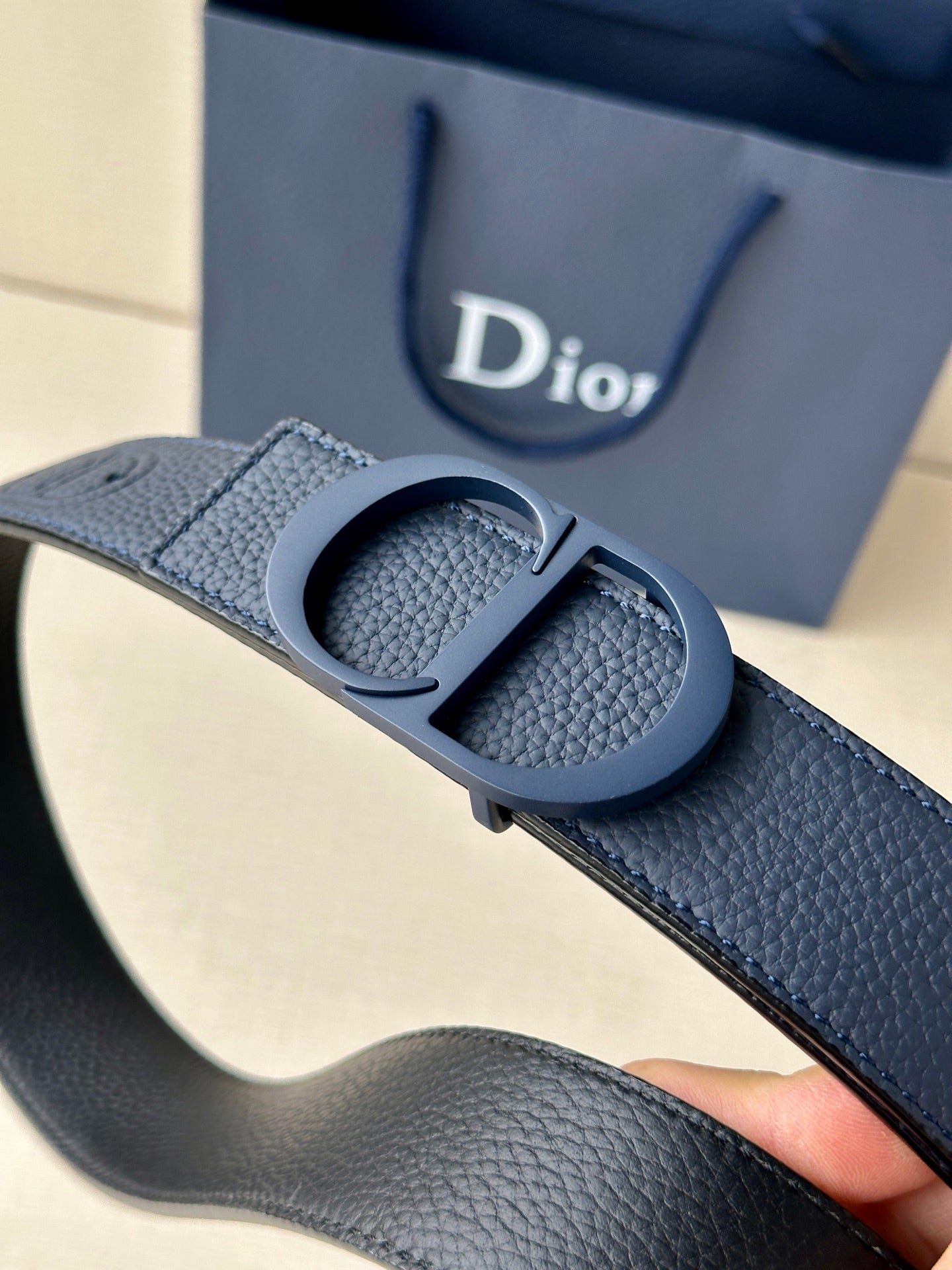 Blue textured leather Dior belt with CD-style buckle and punched strap holes