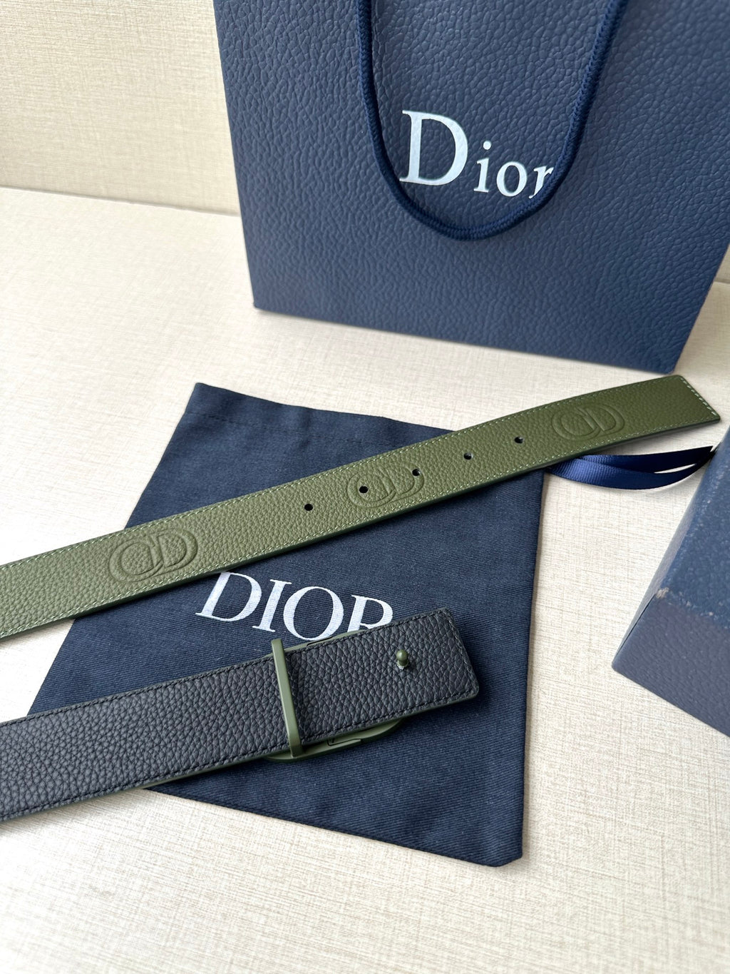 Dior belt and adjustable strap holes in olive green leather with Dior-etched buckle
