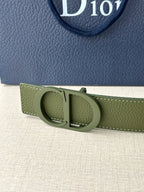 Dior belt buckle close-up in olive green leather with circular clasp and metal bar