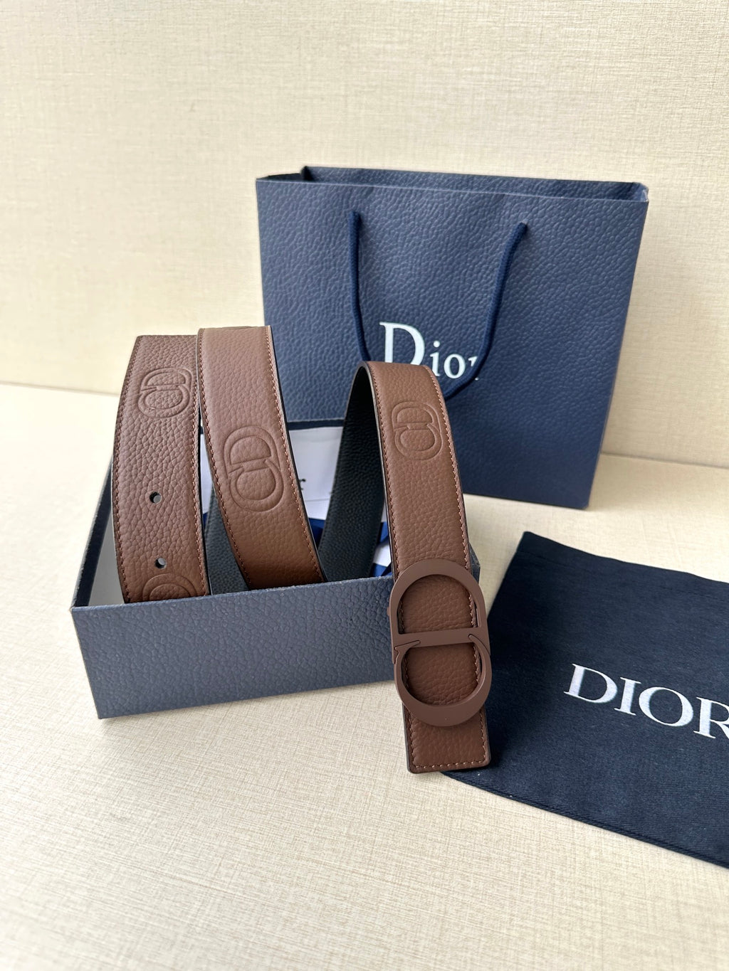 Dior brown leather belt with embossed buckle and coiled strap in gift box