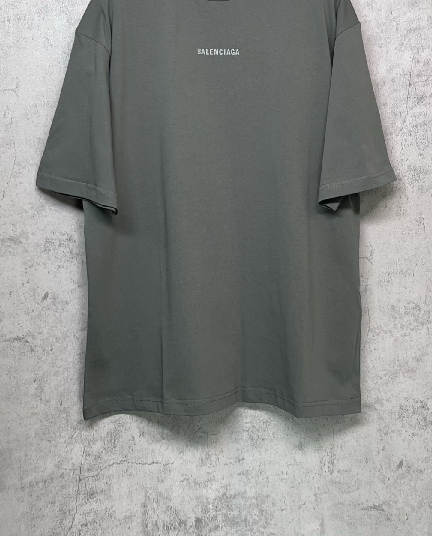 Balenciaga short-sleeve T-shirt, dark gray-green with small chest logo and straight hem.