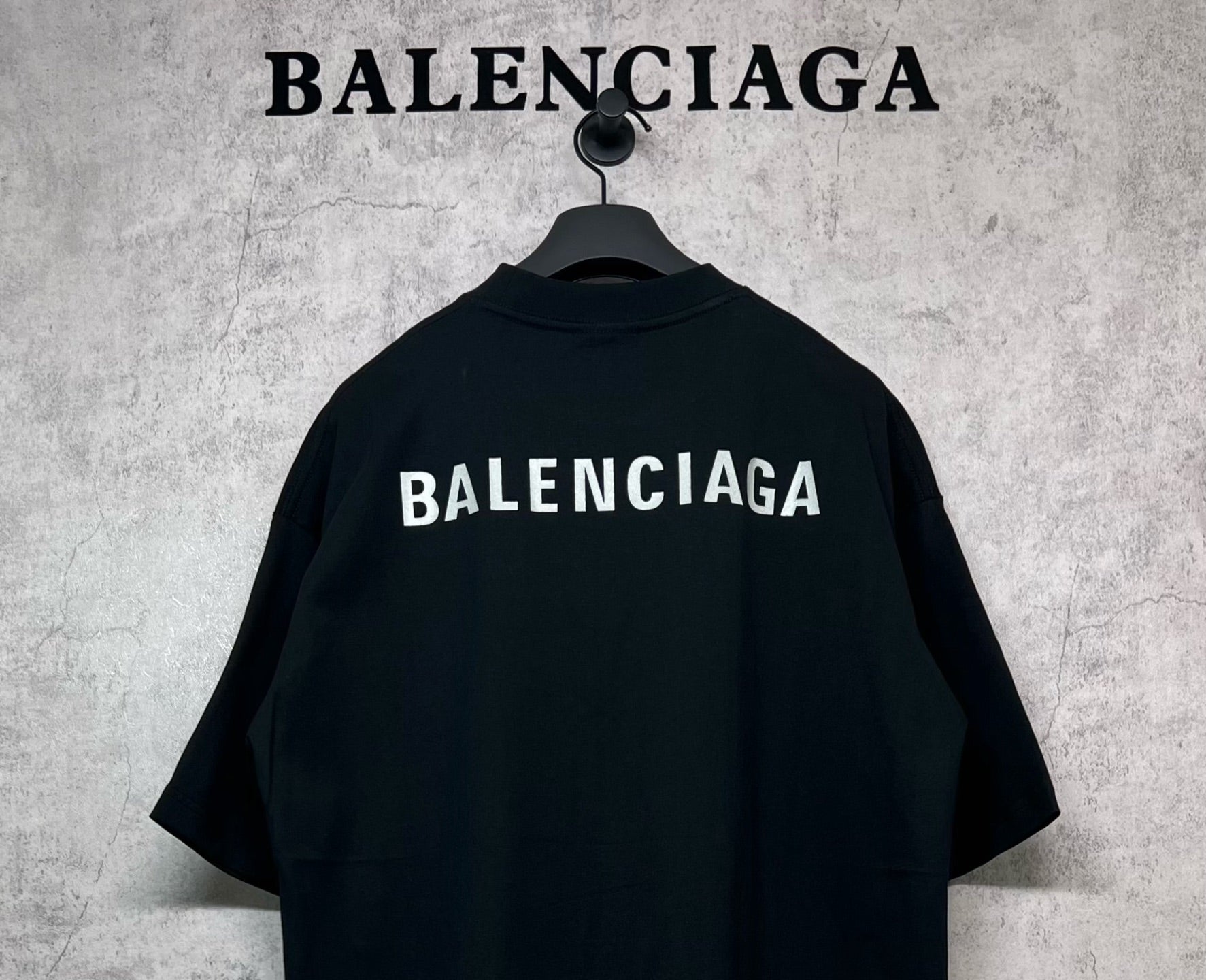 Black crewneck T-shirt with large BALENCIAGA logo across upper back